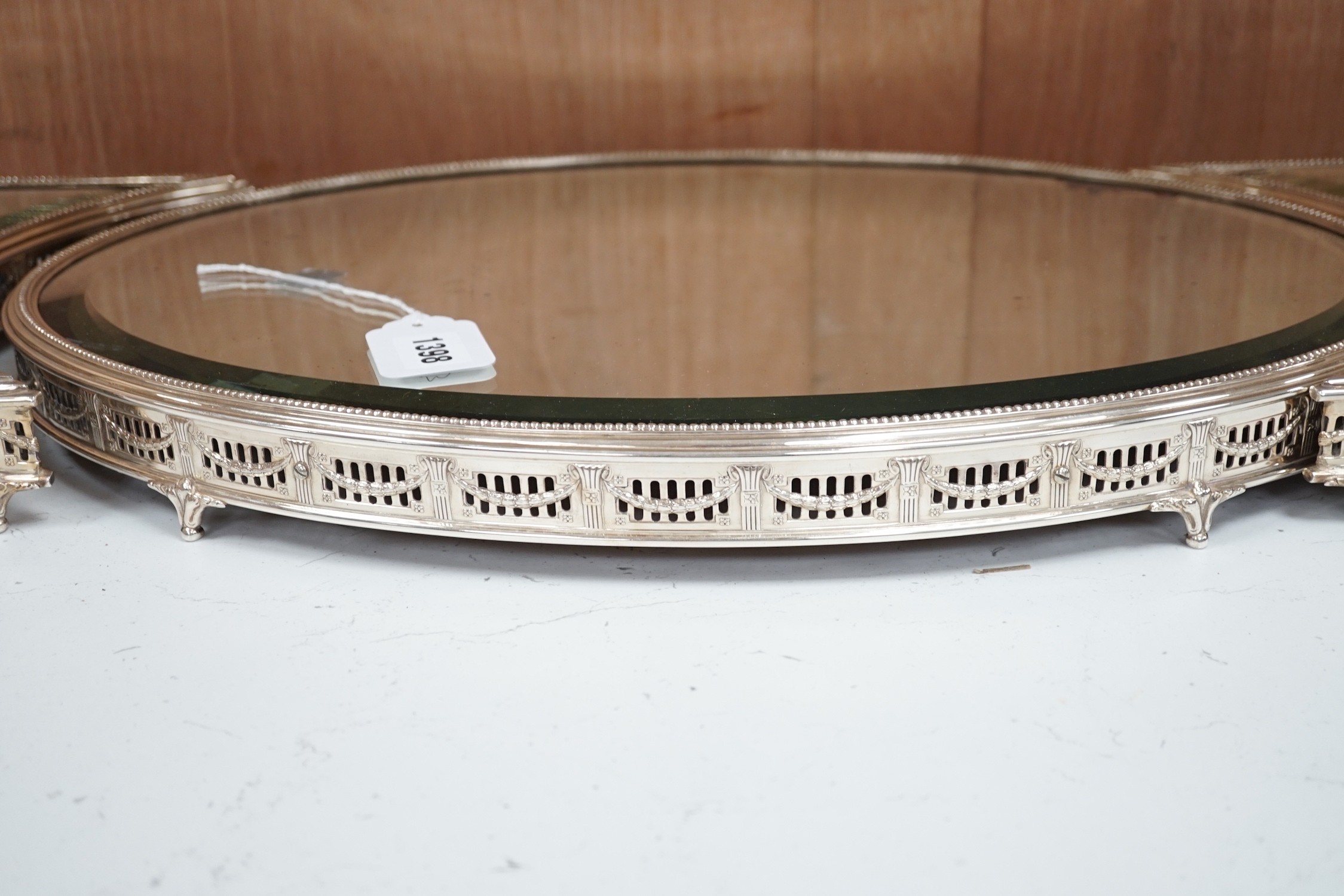 A silver-plated three-section mirrored plateau (surtout de table), by WMF, centre measures 53cm long